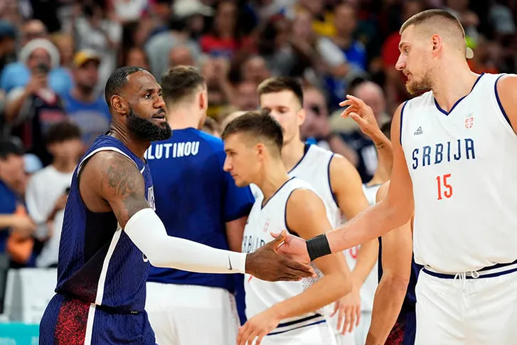 United States guard Lebron James (6) and Serbia power forward Nikola Jokic (15) before a game against Serbia during the Paris 2024 Olympic Summer Games at Stade Pierre-Mauroy.