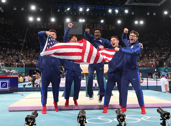 (from left to right) Brody Malone Asher Hong, Frederick Richard, Paul Juda, and Stephen Nedoroscik celebrate after winning bronze during the men’s team final during the Paris 2024 Olympic Summer Games at Bercy Arena on July 29, 2024.