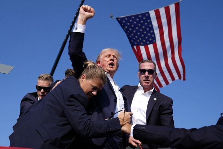 July 13, 2024 | Former President Donald Trump is surrounded by U.S. Secret Service agents after surviving an assassination attempt during a campaign rally in Butler, Pennsylvania.