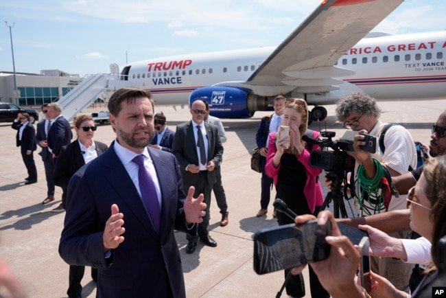 Republican vice presidential nominee Senator JD Vance of Ohio talks to reporters after walking over from looking at Air Force Two, Vice President Kamala Harris' plane, at Chippewa Valley Regional Airport in Eau Claire, Wisconsin, Aug. 7, 2024.