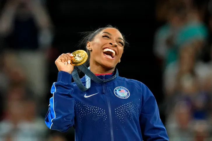 aSimone Biles of the United States celebrates her gold medal during the medal ceremony for the vault on the first day of gymnastics event finals during the Paris 2024 Olympic Summer Games at Bercy Arena on Aug. 3, 2024.