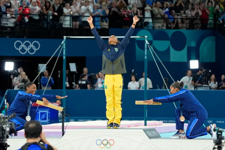 Simone Biles and Jordan Chiles bow to gold medalist Rebeca Andrade of Brazil on the floor exercise on day three of the gymnastics event finals during the Paris 2024 Olympic Summer Games on Aug. 5, 2024.